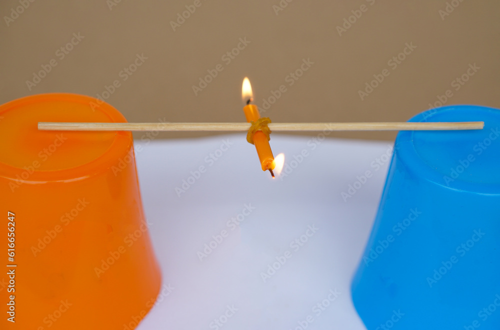 Science experiment about weight balance of burning candle. Concept