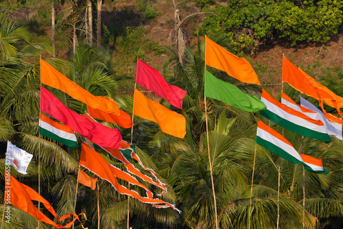 Photograph showing several colorful flags waving in the wind. Flags are also used by communities to identiy its unique presence, location or territory. photo