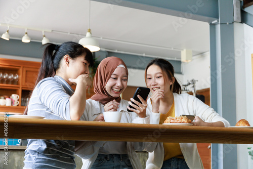 3 happy Ladies chitchat in the cafe with bakery and coffee on the table
