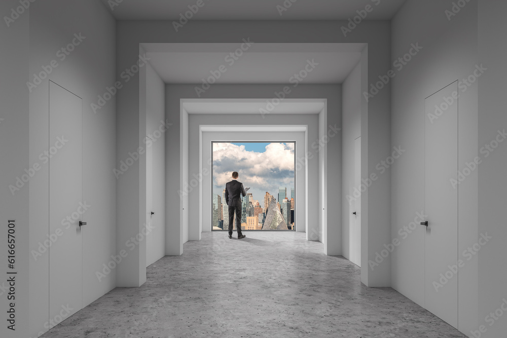 Man looking at city through office window Man looking at city through office window