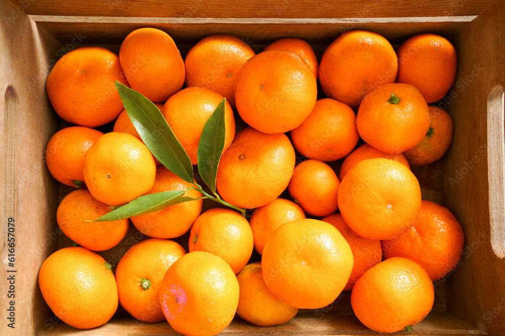 Wooden box of juicy tangerines