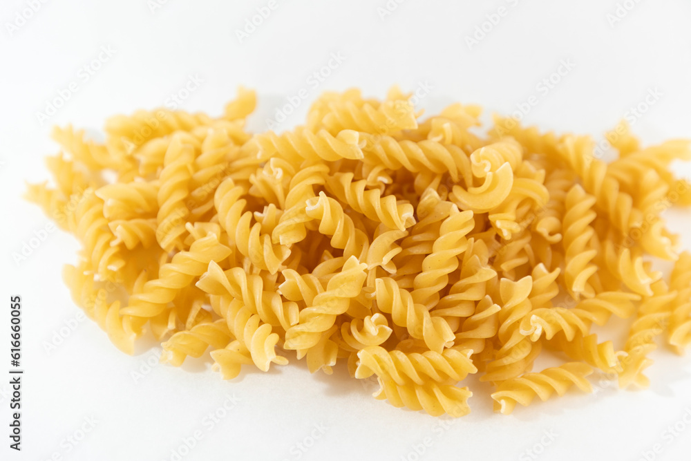 Raw auger pasta on the white background Raw auger pasta on the white background