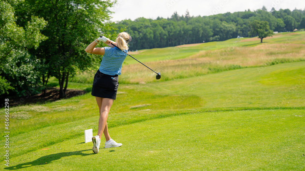 Golfer sport course golf ball fairway. People lifestyle woman playing game golf and hitting go on green grass river. Female player game shot in summer. Copy space banner Golfer sport course golf ball fairway. People lifestyle woman playing game golf and hitting go on green grass river. Female player game shot in summer. Copy space banner
