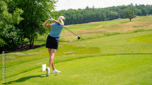Golfer sport course golf ball fairway. People lifestyle woman playing game golf and hitting go on green grass river. Female player game shot in summer. Copy space banner