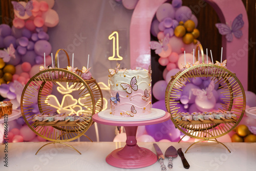 Butterfly themed birthday decor with a beautiful gourmet cake for a party
