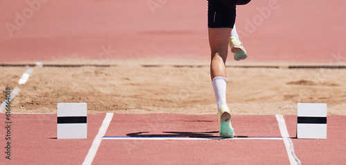 Long jump men athlete jump in athletics competition, sportsman landing his leg on board before taking off in long jump or triple jump