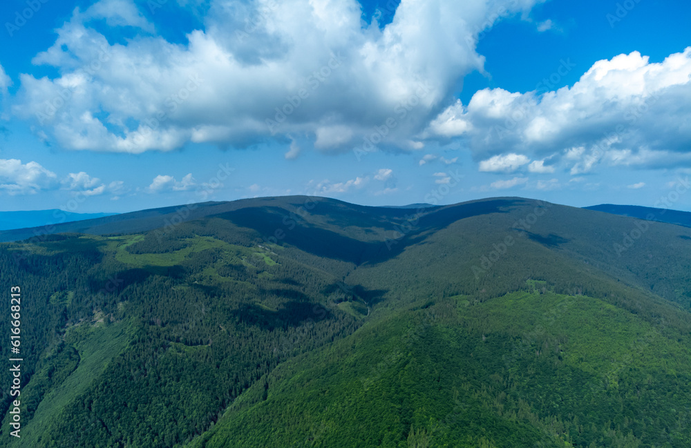aerial view with mountains and valleys covered with green forest. Landscape from the Carpathian mountains in summer