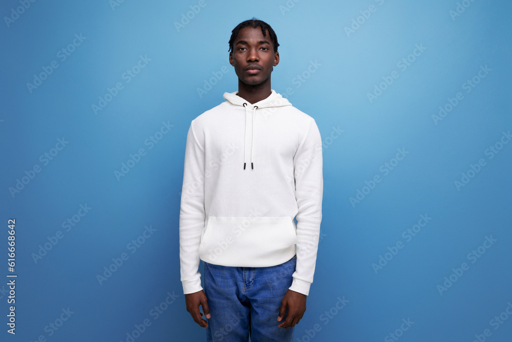 Fototapeta premium stylish american man in white hoodie on blue background