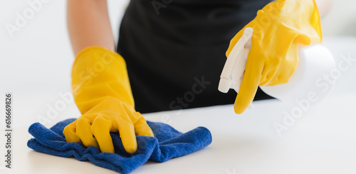 Close up view of person cleaning computer keyboard using tablecloth cleaning concept