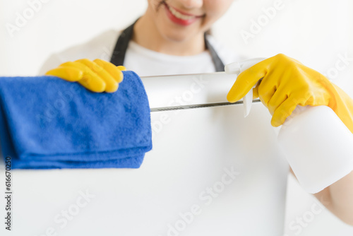 Close up view of person cleaning computer keyboard using tablecloth cleaning concept
