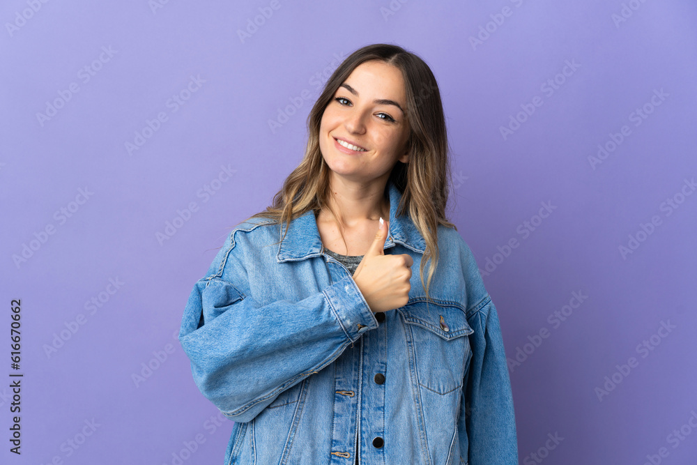 Young Romanian woman isolated on purple background giving a thumbs up gesture Young Romanian woman isolated on purple background giving a thumbs up gesture