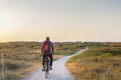 Cyling during dusk to the beach of Formerum at Wadden island Terschelling Friesland province in The Netherlands photo