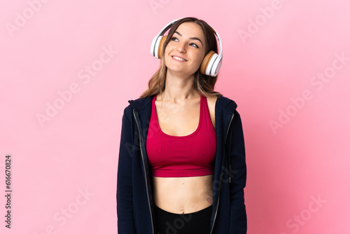 Young Romanian sport woman isolated on pink background thinking an idea while looking up