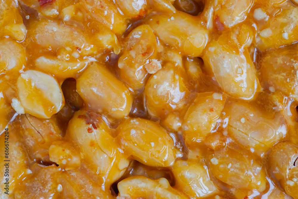 Top view: Gozinaki - caramelized nuts fried in honey - orange granola peanut bar - close up, macro. Traditional Georgian cuisine, oriental sweet, gastronomy and food concept Top view: Gozinaki - caramelized nuts fried in honey - orange granola peanut bar - close up, macro. Traditional Georgian cuisine, oriental sweet, gastronomy and food concept