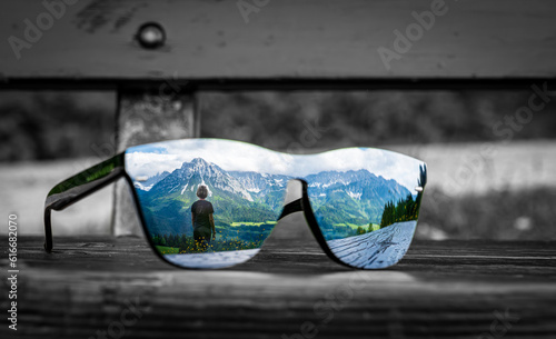Wonderful reflection in sunglasses of an unrecognizable person in front of the Wilde Kaiser mountain in Ellmau Austria