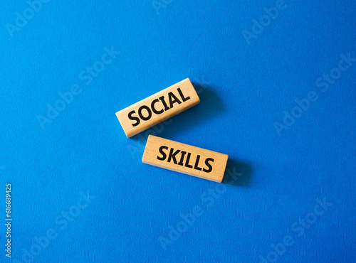 Social skills symbol. Wooden blocks with words Social skills Beautiful blue background. Business and Social skills concept. Copy space.