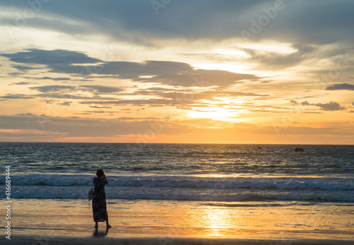 Sunset with a girl absorbing the view