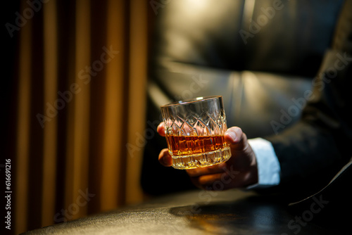 businessmen holding a glass of whiskey