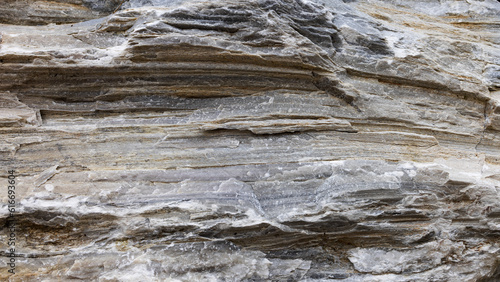 Layered natural stone in Alps with deep cracks. Filled frame 16x9 background screensaver for webinar
