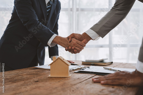 Handshake of real estate brokers with customers or investors, mortgage loan agreements Make a lease-purchase-sell house and home insurance mortgage loan concept.