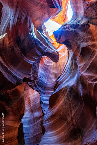 Beautiful vertical wide angle view of amazing sandstone formations in famous Antelope Canyon on a sunny day with blue sky near the old town of Page at Lake Powell, American Southwest, Arizona, USA