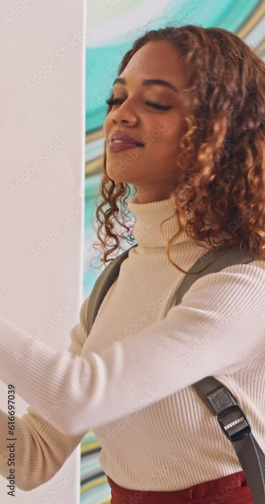 Medium shot of biracial student packing her books into campus locker, walks away Medium shot of biracial student packing her books into campus locker, walks away