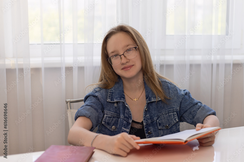 A child with a book smiles into the frame. A child with a book smiles into the frame.