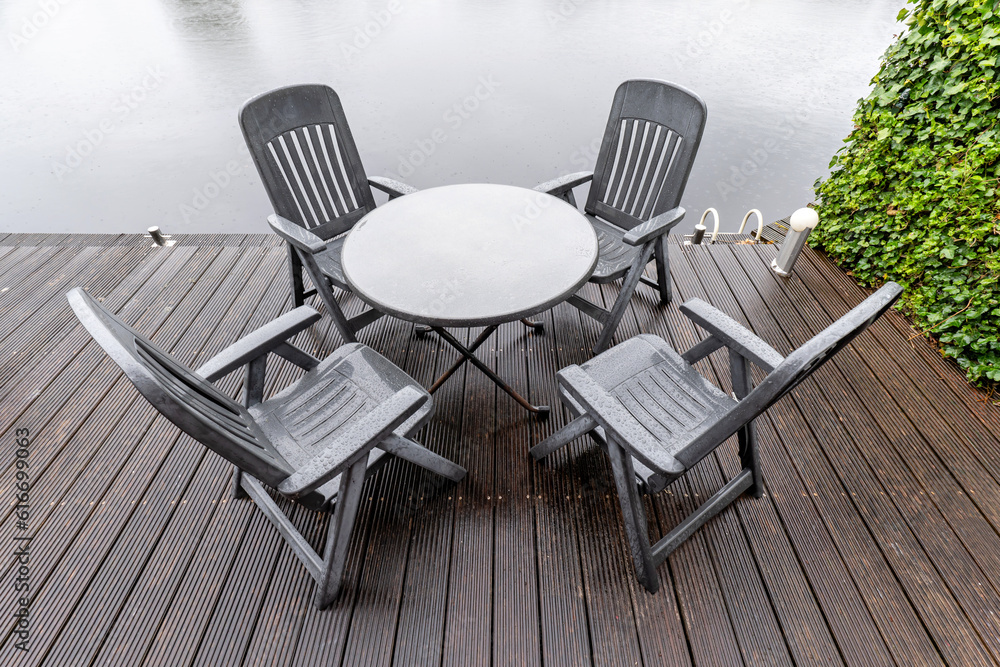 seating group on waterside terrace in rain seating group on waterside terrace in rain