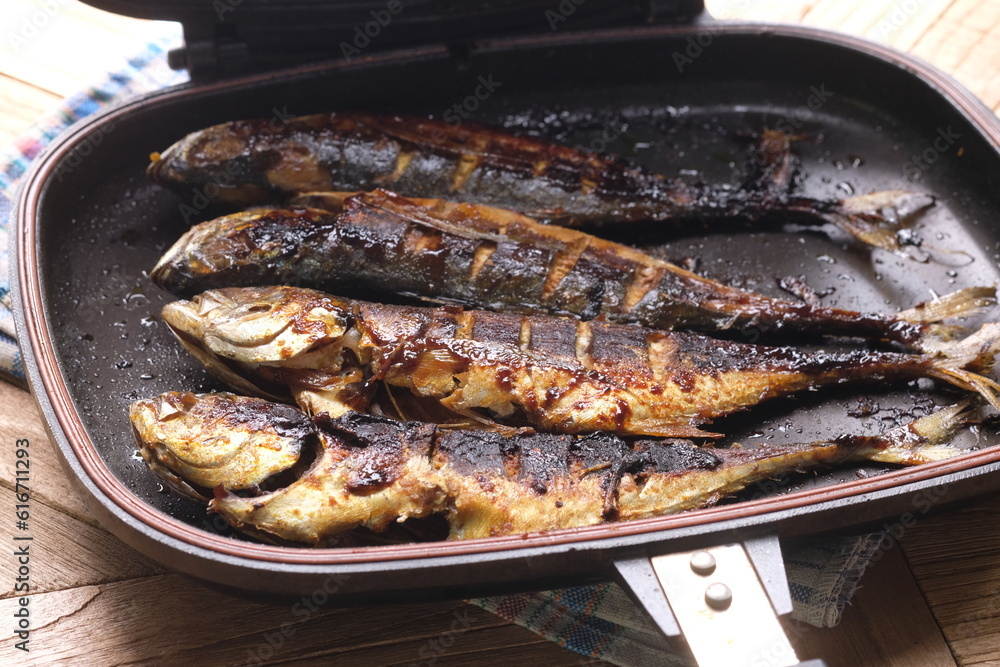Teflon grilled skipjack. fish baked in a teflon-coated pan. Ikan cakalang bakar. Indonesian food.
Teflon grilled skipjack. fish baked in a teflon-coated pan. Ikan cakalang bakar. Indonesian food.