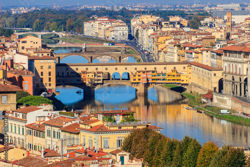 Fototapeta Naklejka Na Ścianę i Meble -  Panoramic view of medieval stone bridge Ponte Vecchio over Arno river in Florence, Tuscany, Italy. View from Michelangelo Hill