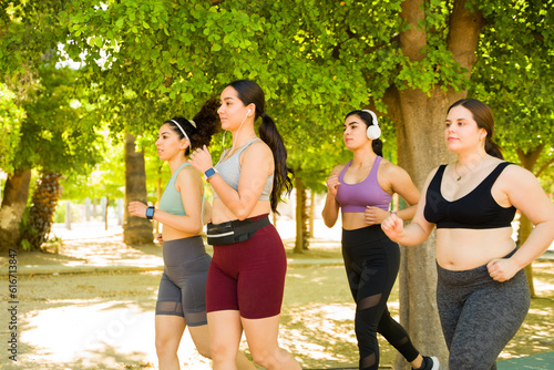 Sporty diverse women with body acceptance running together