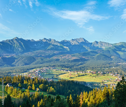 Summer mountain village outskirts and Tatra range behind (Gliczarow Dolny in valley, Poland)