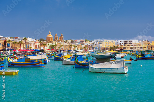 Traditional Luzzu fishing boats at Marsaxlokk harbour, a beautiful Mediterranean town in Malta. © _Danoz
