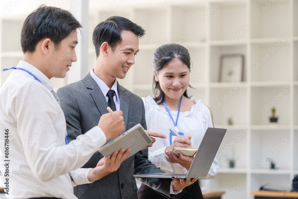 Happy friendly business team using laptop, working together on a new project at modern office. Happy friendly business team using laptop, working together on a new project at modern office.