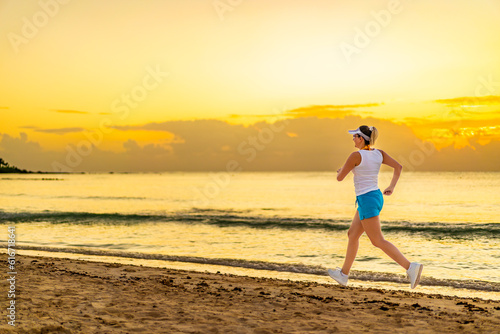 Beach holiday - beautiful woman walking, running on sunny, tropical beach 