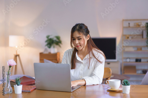 Working at home concept, Women is typing data on laptop while working at modern home office