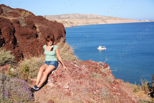Portrait of a girl among the red rocks of Santorini