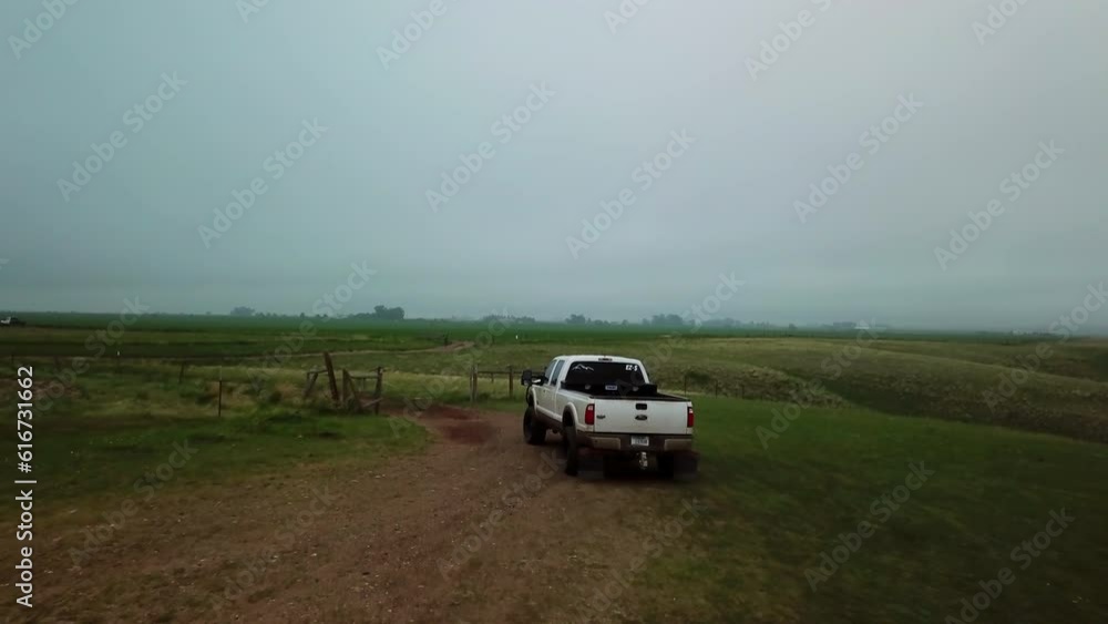 Panning Shot Of White Pickup Truck On Dirt Road Against Sky During Fog - Billings, Montana Panning Shot Of White Pickup Truck On Dirt Road Against Sky During Fog - Billings, Montana