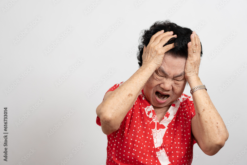 A senior woman who has a severe headache suffers from a stroke ,brain disease,patient holding head with her hand,suffering from senile dementia,memory disorders, confused old elderly with Alzheimer A senior woman who has a severe headache suffers from a stroke ,brain disease,patient holding head with her hand,suffering from senile dementia,memory disorders, confused old elderly with Alzheimer