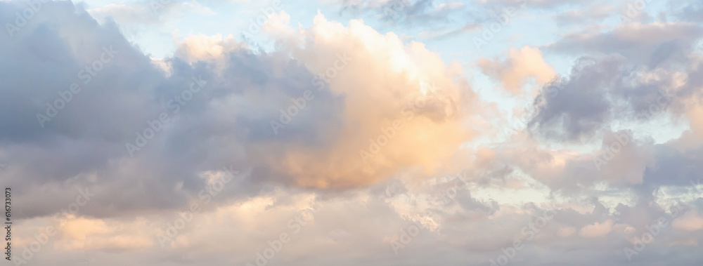 Beautiful fluffy clouds painted in bright painterly colors at sunrise. Banner. Multicolor nature background or wallpaper Beautiful fluffy clouds painted in bright painterly colors at sunrise. Banner. Multicolor nature background or wallpaper