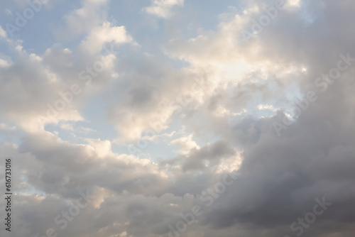 Beautiful blue sky and white fluffy cloud with sunrise in the morning. Natural background or atmosphere wallpaper