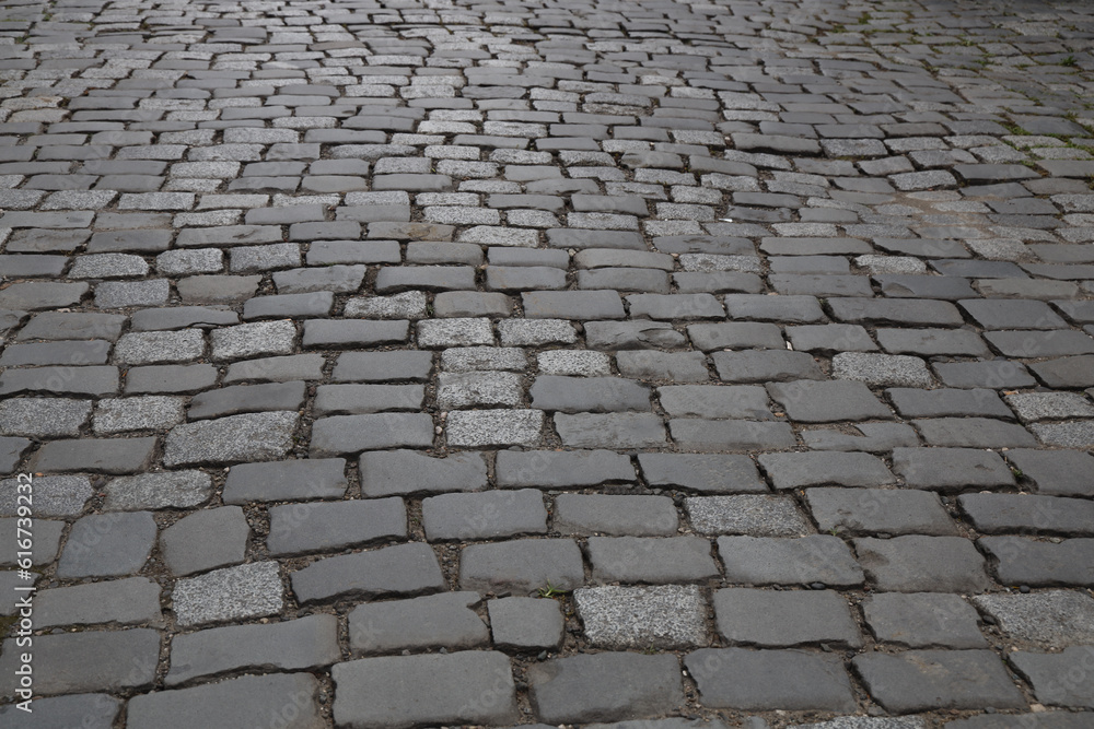 mock-up. Old square cobblestone paving perspective background. mockup. retro, aged cobbled stone road background. mockup. grey cobble stone pavement texture. mock up.