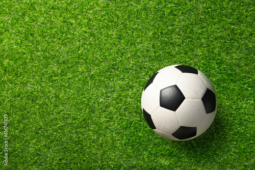 Top view of football ball on grass field.