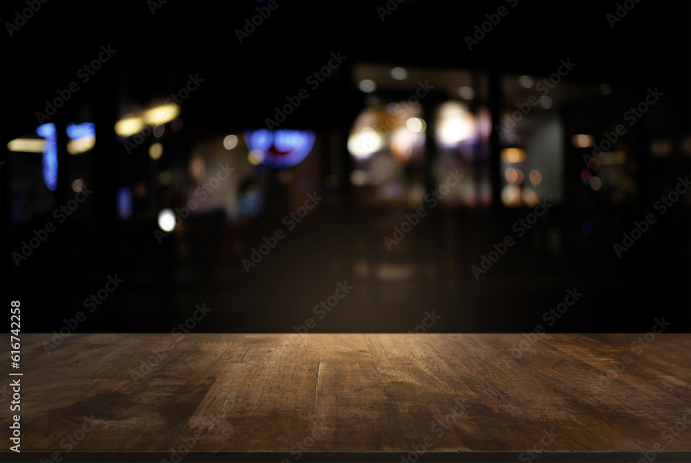 Empty of dark wooden table in front of abstract blurred background of bokeh light . can be used for display or montage your products.Mock up for display of product