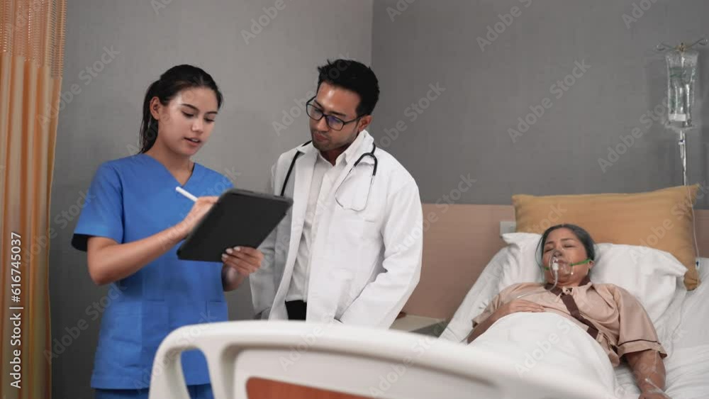 Doctors and nurses check patient outcomes in the recovery room after treatment. Doctors and nurses check patient outcomes in the recovery room after treatment.