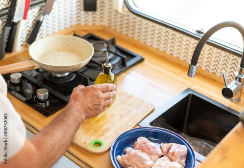 Wallpaper Mural older man cooking in his motorhome, Torontodigital.ca