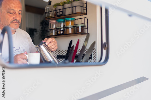Wallpaper Mural man serving himself coffee in his motorhome kitchen Torontodigital.ca