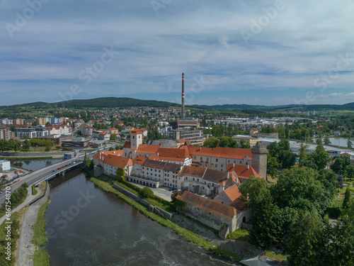 Aerial view of Strakonice castle next to the Otava river in Czechia with Gothic, Baroque palace and restored circular donjon with edge called Rumpal tower photo