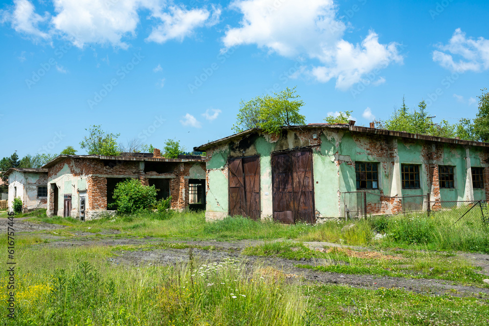 Abandoned brick warehouse buildings in a small  mountain settlement in Romania.
