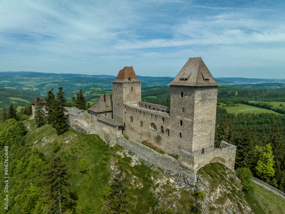 Aerial view of Kasperk Hrad or Karlsberg castle in Czechia. The central part of the castle consists of two residential towers and an oblong palace which was built between them Aerial view of Kasperk Hrad or Karlsberg castle in Czechia. The central part of the castle consists of two residential towers and an oblong palace which was built between them